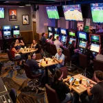FABET bettors enjoy online sports betting in a lively casino environment with multiple screens.