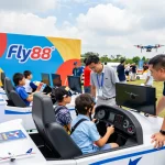 Engaging aviation-themed event highlighting Fly88 with families enjoying flight simulations.