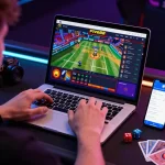 Engaging online gambling experience on Five88 platform with live sports betting, laptop and smartphone displaying vibrant game statistics.