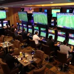 Engaged bettors exploring kèo nhà cái options in a lively sports betting lounge.